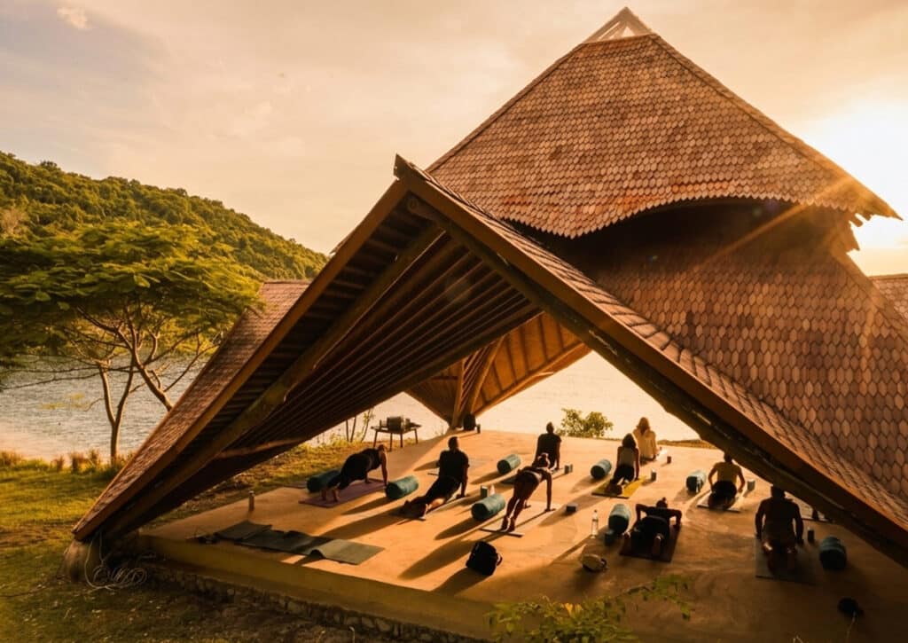 Open-air yoga shala at Kirana Retreat Sumbawa at golden hour with ocean views